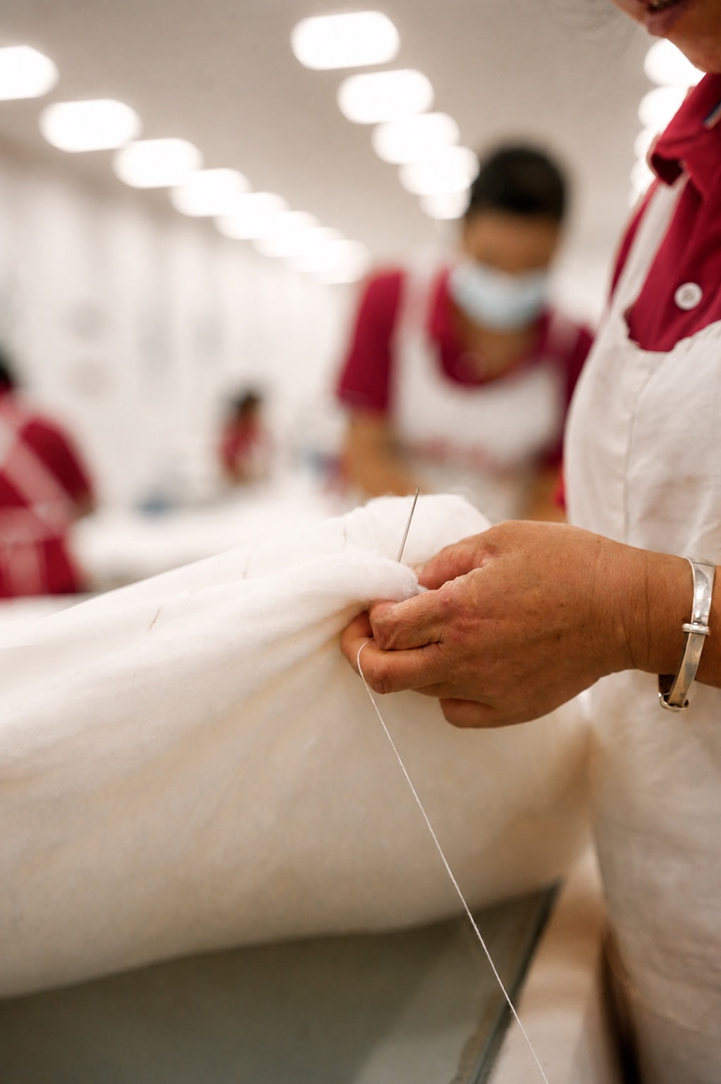 Hands carefully stretching a continuous silk layer
